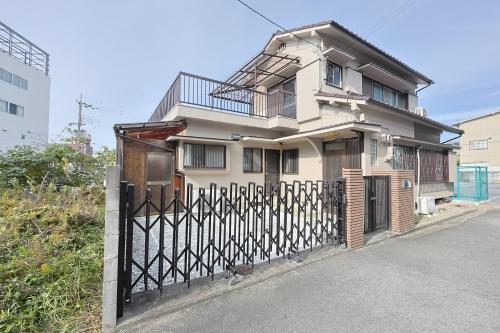 a house with an iron gate with a fence at Authentic Local Experience House in Nara