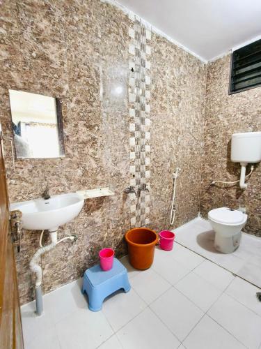 a bathroom with a sink and a toilet at Sai Tara Residency in Shirdi