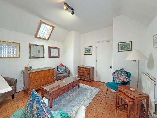 a living room with a couch and a table at The Courtyard Cottage in Llangollen