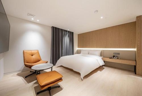 a hotel room with a bed and a chair at 서초 Hotel Brick in Seoul