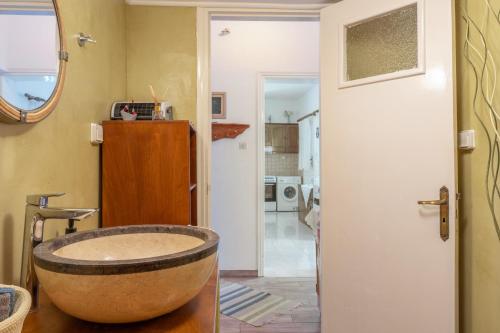 a bathroom with a tub in the middle of a room at Hippocrates' House in Amorgos