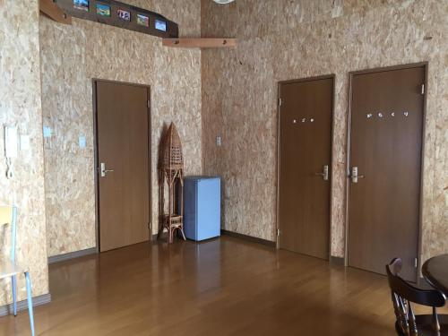 a room with four doors on the wall at Natsumi no Sato in Biei