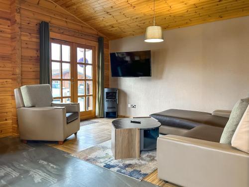 a living room with a couch and a table at Lodge 3 - Uk51250 in Glasgow