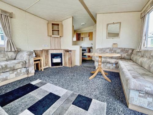 a living room with a couch and a table at The Medway - Uk51004 in Eastchurch