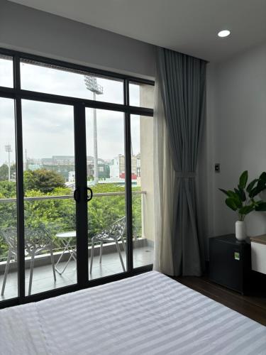 a bedroom with a bed and a large window at SQUIRRELHOME District8 in Ho Chi Minh City