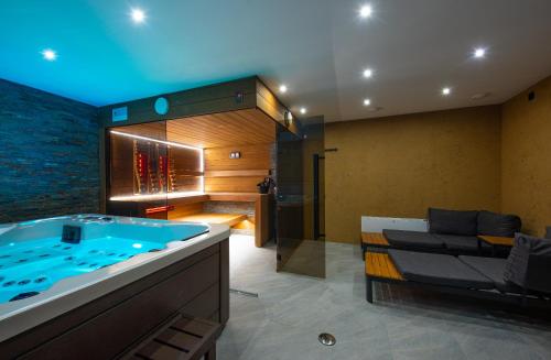 a large bathroom with a tub in a room at Wellness Vila Žakovce s bazénom in Veľká Lomnica