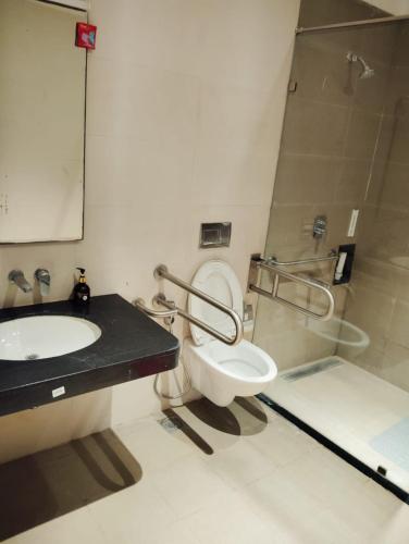 a bathroom with a toilet and a sink and a shower at Abhushan Mahal in Nīmri