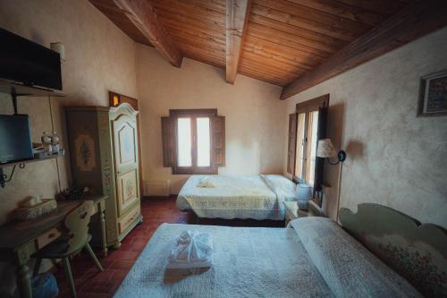 a bedroom with a bed and a couch in a room at Agriturismo La Marletta in Imola