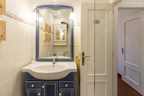 a bathroom with a sink and a mirror at Las Camelias in Argoños