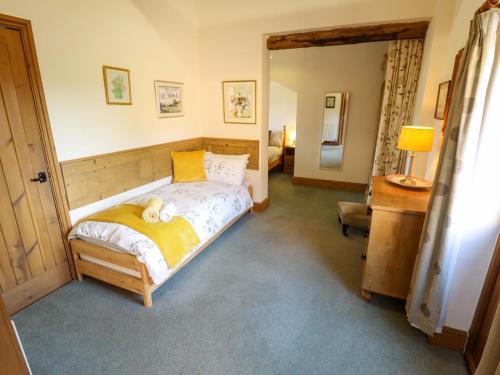 a bedroom with a bed with a teddy bear on it at Ticklepenny in Louth