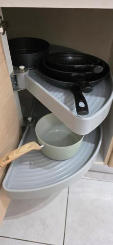 a black toilet sitting on a shelf with a bowl at Fare Iki in Papeete