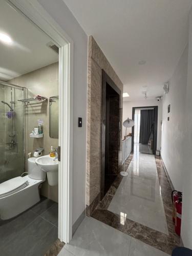 a bathroom with a sink and a toilet and a shower at SQUIRRELHOME District8 in Ho Chi Minh City