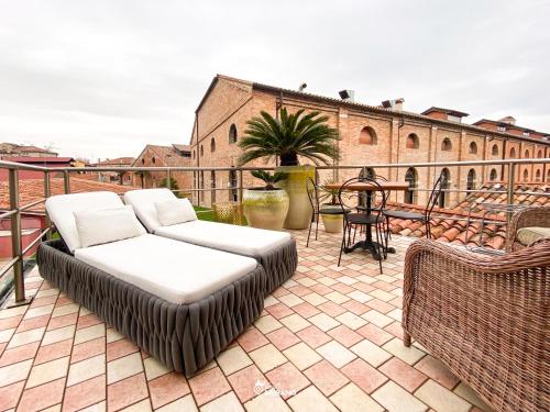 a couch sitting on top of a balcony at MURANO Suites - Venezia in Murano