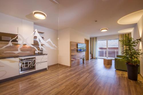 a living room with a stove and a couch at Aparthotel AlpTirol in Kaltenbach