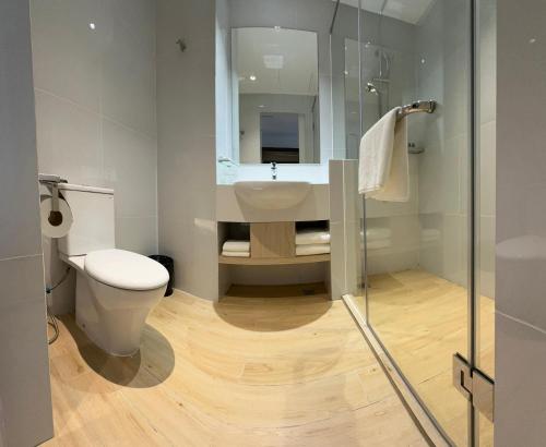 a bathroom with a toilet and a sink and a shower at Sri Gaya Hotel in Kota Kinabalu
