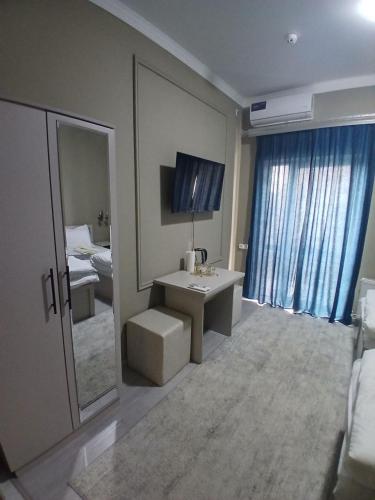 a bathroom with a sink and a mirror and a bed at Xonobod НОТЕL in Khiva