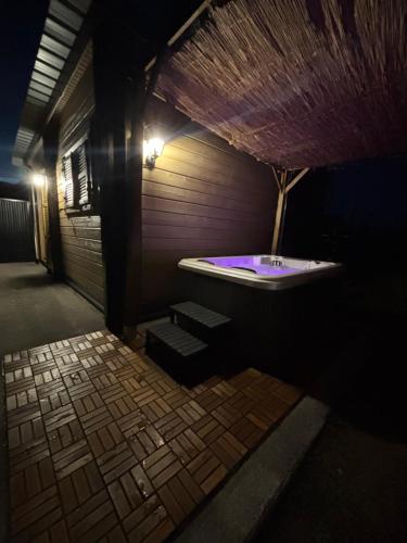 a bathroom with a bath tub with purple lighting at Chalet Des Aigrettes- Jacuzzi privatif in Chassey-lès-Montbozon