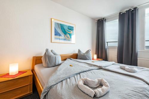 a bedroom with a bed with a towel on it at Nordseeblick in Bremerhaven