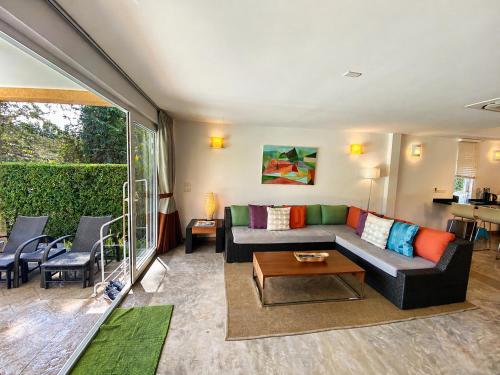a living room with a couch and a table at Royal Shell by Utalay Koh Chang in Ban Khlong Son