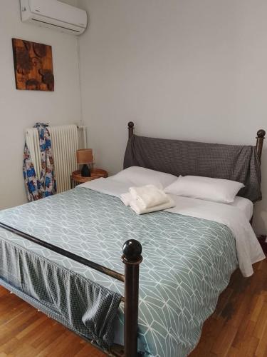 a bedroom with a large bed with white sheets at Savelona's Guest Appartment in Agrinio