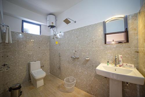 a bathroom with a sink and a toilet at Sumitel Sonam Lachung in Lachung