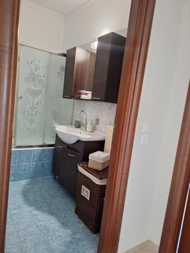 a small bathroom with a sink and a mirror at Dimitra's APARTMENT NAFPLIO in Nafplio