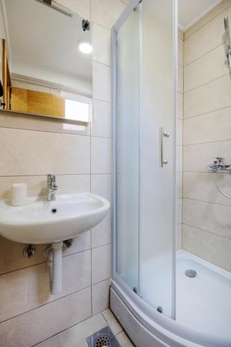 a bathroom with a sink and a shower at Apartments Sunce in Neum