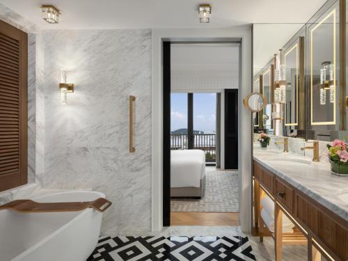 a bathroom with a tub and a sink at The Laurus, a Luxury Collection Resort, Singapore in Singapore