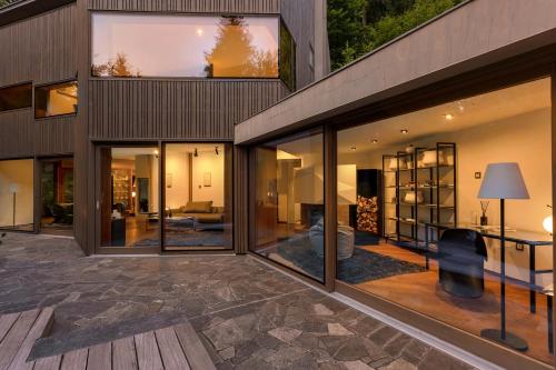an external view of a house with large glass windows at Villa Jasna in Kranjska Gora
