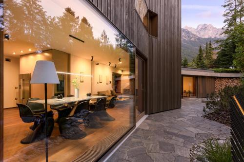a dining room with a table and black chairs at Villa Jasna in Kranjska Gora