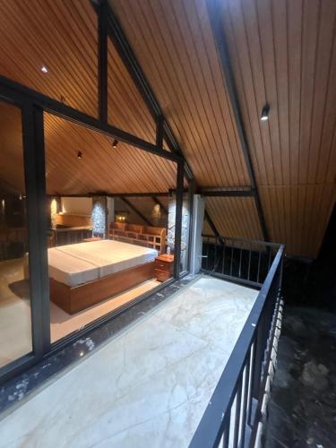 a large room with a bed at The Pebble Shack in Idukki