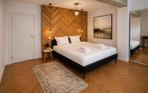 a bedroom with a large bed with a wooden headboard at Arena Park in Bucharest