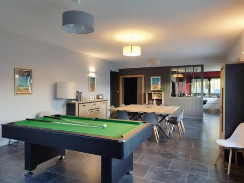 a living room with a pool table in it at Villa de l'Olivier in Aytré