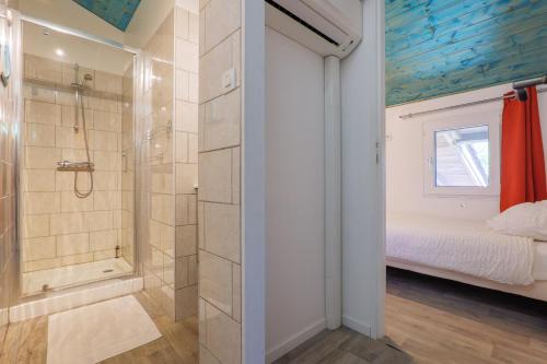 a bathroom with a shower and a bed in a room at Mas du soleil levant in Les Vans