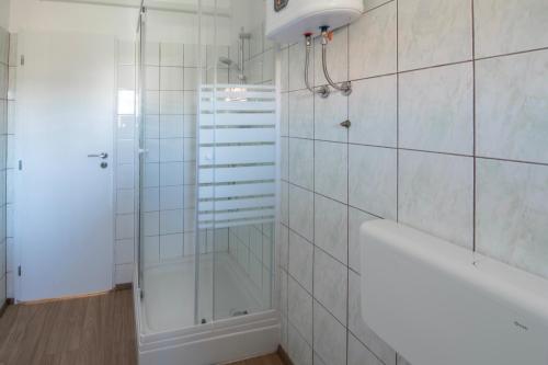 a bathroom with a shower and a bath tub at La Casetta di Gio in Pula