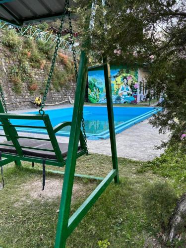 a swing in front of a swimming pool at Stay Maasa Resort in Shivpuri