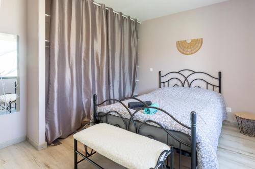 a bedroom with a bed and a chair and a window at Maison Lahourcade in Lahourcade