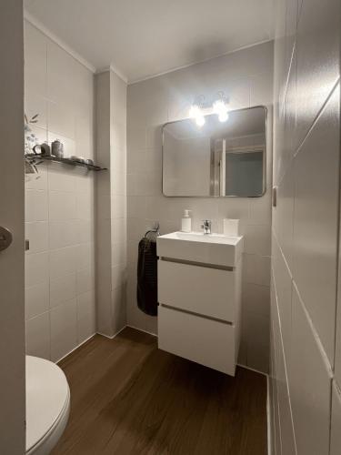 a white bathroom with a sink and a mirror at Pedro in Roses