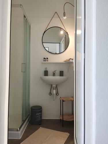 a bathroom with a sink and a mirror at Filia Bungalow in Archangelos