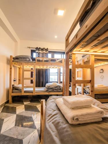 a room with four bunk beds in a room at Adventure valley Rajgundha in Kangra