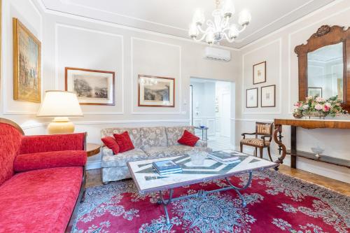 a living room with a couch and a table at GuestHost - Chic Central Apartment in Montecatini in Montecatini Terme