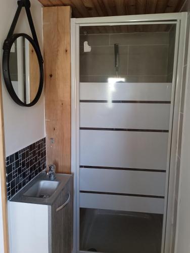 a bathroom with a sink and a mirror at Chalet lac Celinda in Saint-Mamet