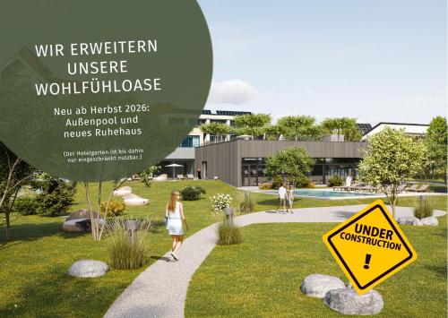 a woman walking down a sidewalk with a sign at Hotel Traube am See in Friedrichshafen