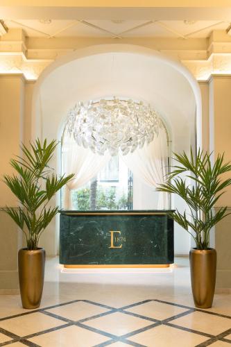 a room with two potted plants and a chandelier at EST Hotel Palais Chotek NEW OPENING in Vienna