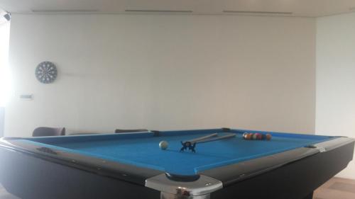 a blue pool table with a ball on it at Mercure Karawang in Karawang
