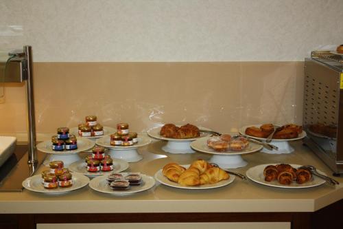 a bunch of food on a counter with plates of food at Domus Australia in Rome
