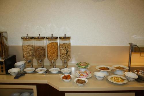 a counter top with bowls and vases filled with food at Domus Australia in Rome
