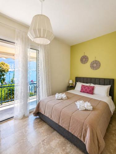 a bedroom with a large bed and a large window at Vassia's B rooms in Poros