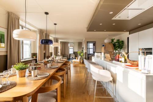 a dining room with a long table and chairs at Copenhagen Collection King's Garden Stay in Copenhagen