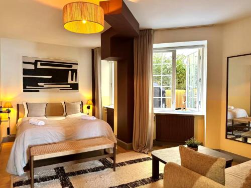 a bedroom with a bed and a large window at Copenhagen Collection King's Garden Stay in Copenhagen